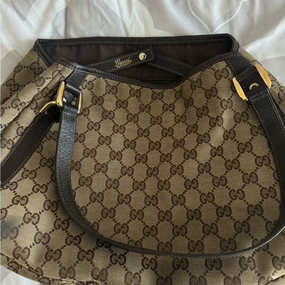 This is authentic Gucci monogram canvas hobo bag.